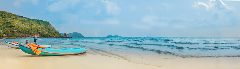Panorama. Tropical Seascape with Sky Mountain and sea , blue boat on white beach.Summer holiday