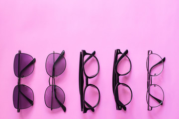 Top view, Set glasses or sunglasses object fashion minimal modern style, accessory travel on Pink pastel color background.