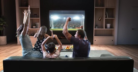 A family is watching a soccer moment on the TV and celebrating a goal, sitting on the couch in the living room. The living room is made in 3D. - Powered by Adobe