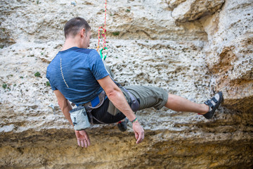 Photo from back of climbing sports man on rock