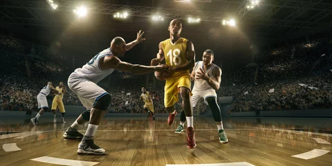 Poster Basketball players on big professional arena during the game. Tense moment of the game. Male caucasian and black players fight for the ball © Alex