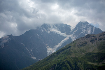 Fototapeta na wymiar Image of mountain slopes with vegetation, cloudy sky
