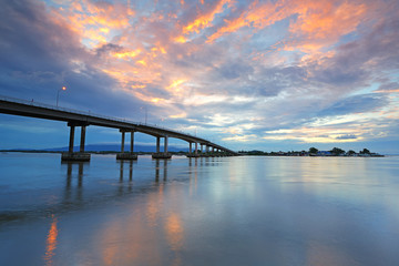 Fototapeta na wymiar Concrete bridge over the sea during the sunrise, Chanthaburi Thailand