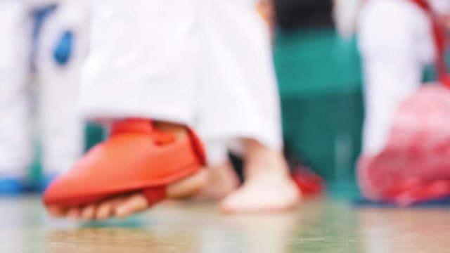 Feet of a karate child during a fighting rack