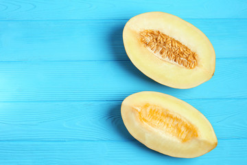 halves of a melon on a blue table