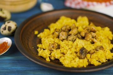 porridge of lentils with fried meat on a plate