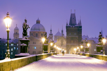Fototapeta na wymiar winter snowy Charles bridge, gothic Old Town bridge tower,Old town district, Prague (UNESCO), Czech republic, Europe