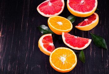 orange and grapefruit juice On a wooden black background
