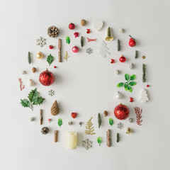 Christmas decoration wreath made of various winter and holiday objects. Minimal New Year flat lay...