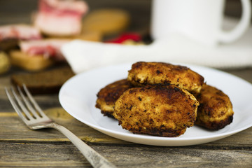 meat fried cutlets on a plate on a wooden board