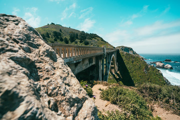 crag and mountains with train bridge