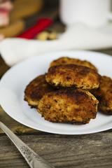meat fried cutlets on a plate on a wooden board