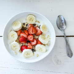 Breakfast bowl with yogurt, muesli, strawberries, banana