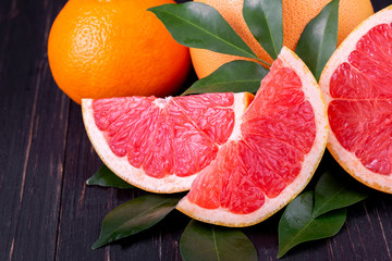 orange and grapefruit juice On a wooden black background