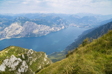 Lake Garda (Italy) and the mountains that surround it seen from the top of Monte Baldo. Italian landscape.
