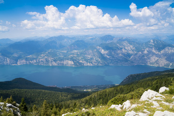 Fototapeta na wymiar Lake Garda (Italy) and the mountains that surround it seen from the top of Monte Baldo. Italian landscape.