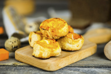 Baked roll with pumpkin and cheese stuffing on a wooden board