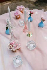 Wedding decor on restaurant table. Pastel blue vase and peony flower, close-up detail photo