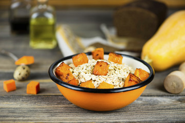 oatmeal porridge with stewed pumpkin in a plate