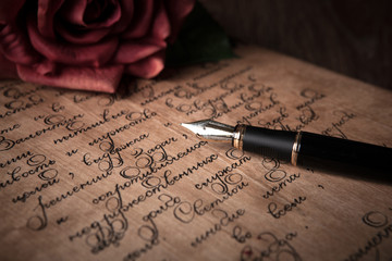 fountain pen on letter with text and red rose - obrazy, fototapety, plakaty