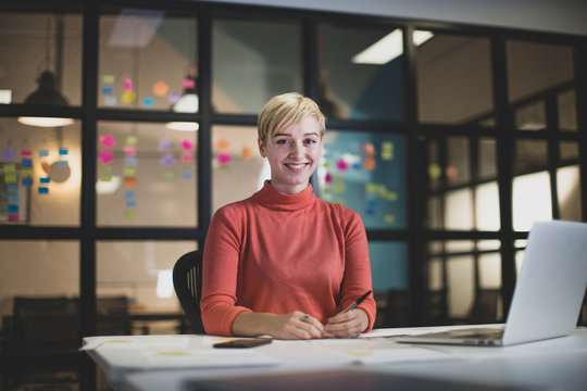 Portrait young adult female working late in an office