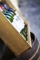 Five empty bottles in a wooden box