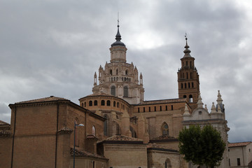 Fototapeta na wymiar The Nuestra Señora de la Huerta Gothic and mudejar cathedral dome and bell tower in a cloudy, autumn day in Tarrazona, Aragon, Spain