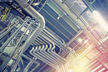 Fototapeta premium Equipment, cables and piping as found inside of a modern industrial power plant