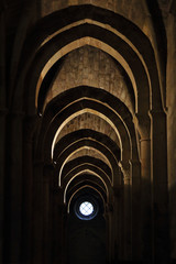 A series of horseshoe moorish arches in backlight and a window in the Veruela Cistercian abbey, in Aragon region, Spain