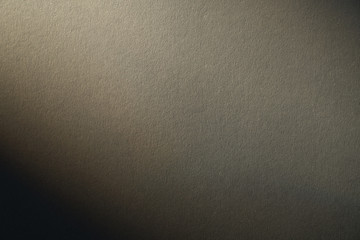 light gradient on a grey cardboard background