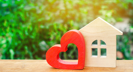 House with a red wooden heart. House of lovers. Affordable housing for young families. Valentine's...