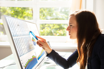 Businesswoman Analyzing Graphs On Computer