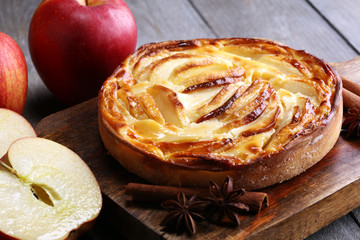 Naklejka na ściany i meble Apple tart. Gourmet traditional holiday apple pie sweet baked dessert food with cinnamon and apples on vintage background. Autumn decor. Rustic style.