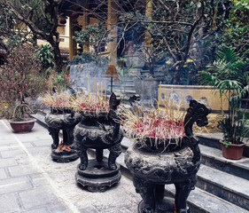 Area in front of the temple, incense smoke rise up, an Asian temple