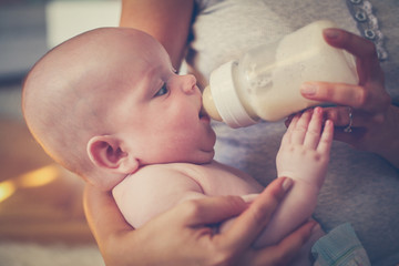 Mother with her son at home..Mother feeds her little baby.