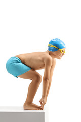 Young boy swimmer preparing to jump