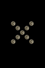 Real snapshot of the full moon in a low key on a black background