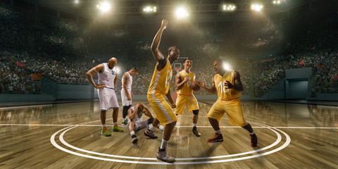 Basketball players emotionally rejoice at victory on professional basketball stadium. Players from...