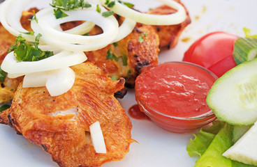 Delicious grilled shashlik with adjika and vegetables.