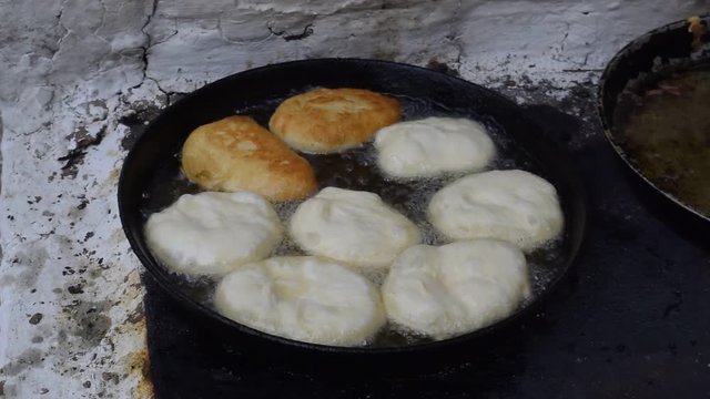Fry the patties in oil in a frying pan on the stove. Traditions of cooking pies. Appetizing toasted pies.