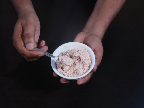 Black Salt Powder, black ground salt from the Himalayas heap pile close up isolated ,Indian Black salt, Kala namak,,Kala namak or Black salt,Black salt in white bowl on wooden background,