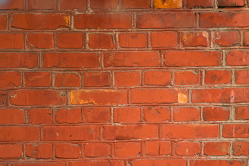 red brick wall with traces of old age and with different shades of bricks