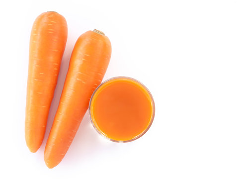 Closeup top view glass of carrot juice and fresh carrot isolated on white background, healthy diet food drink