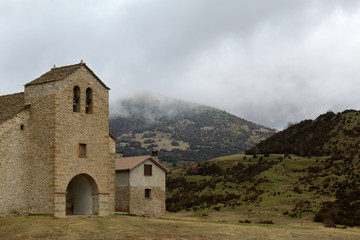 Fototapeta premium The Santa Orosia sanctuary in the foggy and cloudy mountains next to Yebra de Basa small town in the Aragonese Pyrenees, Spain