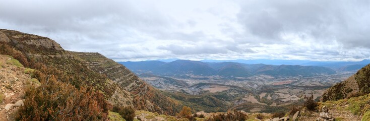 Blue cloudy sky and typical mountains and hills covered with forest met in autumn while hiking from...
