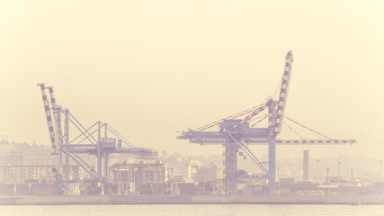 Port of Naples with crane and fog