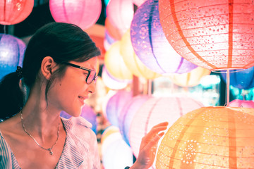 Young girl playing with traditional Chinese mid-autumn lanterns. 