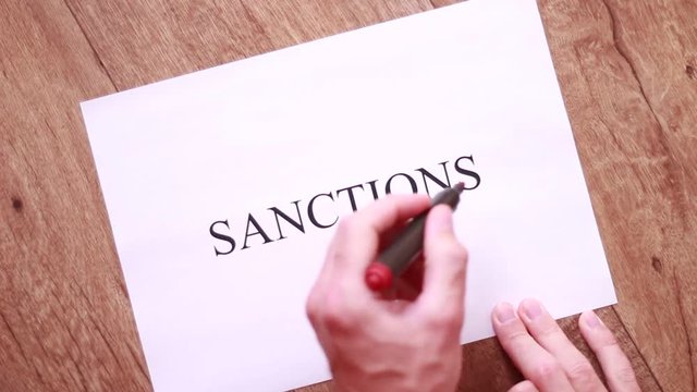 "Sanctions" inscription crossed with red line