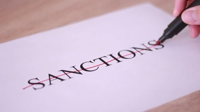Crossing "Sanctions" inscription with red marker