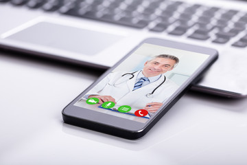 Mobile Phone Showing Video Conference Of A Doctor